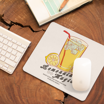Desk setup with Lemonaided Magic mousepad featuring hand-drawn custom sigil — Mercury Loves Osiris, e pad with lemonade design on a wooden desk with keyboard and notebook.