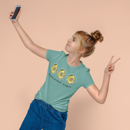 Model wearing Lemonaided Magic personalized sigil T-shirt — custom affirmation design by Mercury Loves Osirist, making a peace sign against a beige background